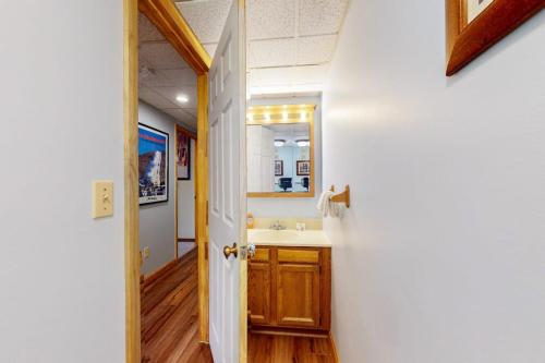 a bathroom with a sink and a mirror at Mountain Green - 2E3 in Killington