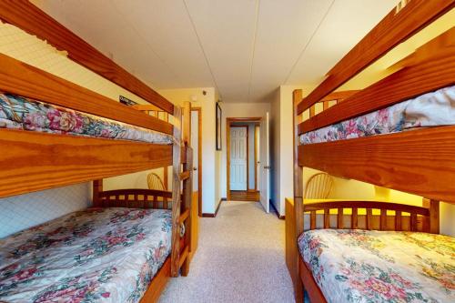 a bedroom with two bunk beds and a hallway at Mountain Green - 2E3 in Killington
