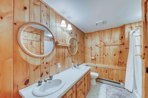a bathroom with a sink and a mirror and a toilet at Log Cabin with a View in Andover