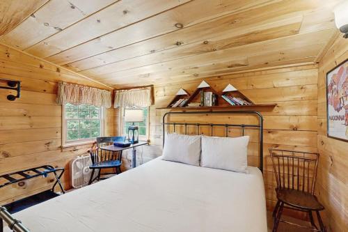 a bedroom with a bed in a wooden room at Wandering Trails Retreat in Cambridge