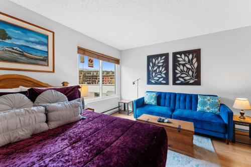 a living room with a blue couch and a blue sofa at Blazing Saddles #102 in Breckenridge