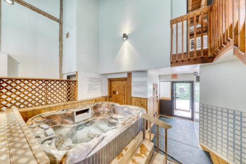 a large tub in the middle of a room at Mountainside Resort F303 in Stowe