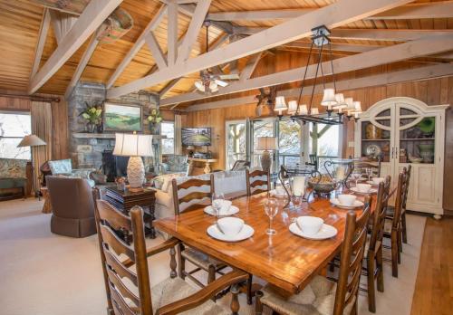 a dining room with a large wooden table and chairs at Out On A Limb in Blowing Rock