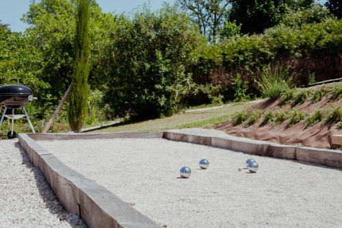 three blue helmets sitting in the sand in a garden at Tiny House - Nature&calme - Pétanque&barbecue in Quincey