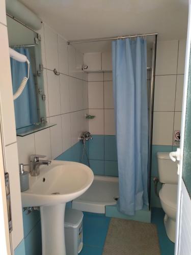a bathroom with a sink and a toilet and a shower at Magic Ionian Apartments & Rooms in Himare