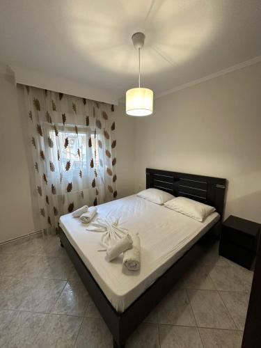 a bedroom with a bed with towels on it at Paul House in Metamorfosi