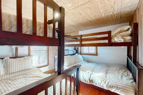 two bunk beds in a room with two beds at Lakefront Living in Bomoseen
