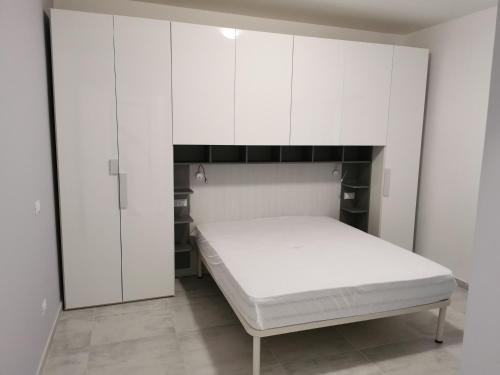 a white bedroom with a bed and white cabinets at Mare e Trabocchi in Fossacesia