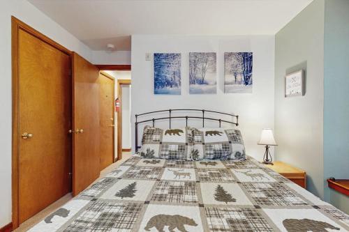 a bedroom with a bed with a bear patterned bedspread at The Seasons G17 in West Dover