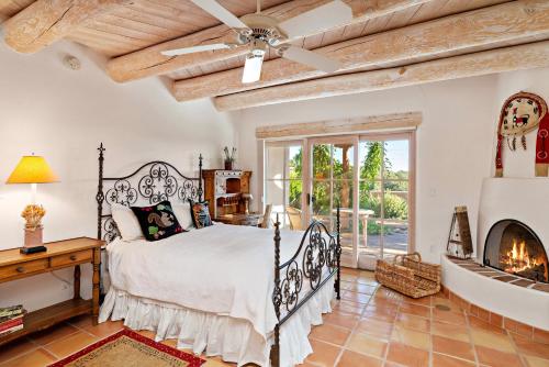 a bedroom with a bed and a fireplace at Quail run in Santa Fe