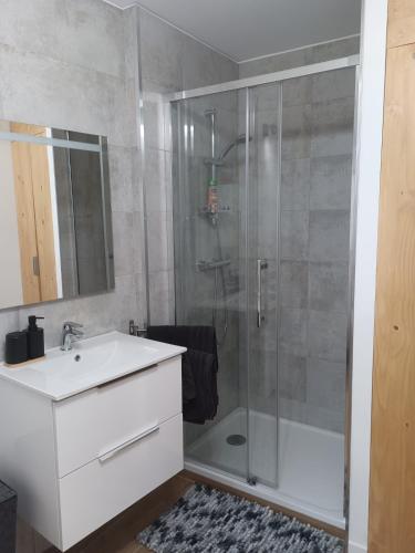 a bathroom with a shower and a sink and a tub at DUPLEX 3eme étage in Le Vigan