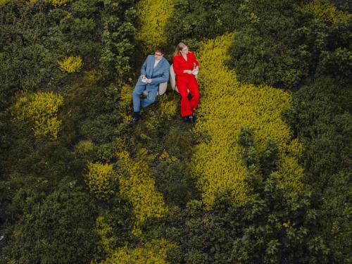 a man and woman sitting in a field of flowers at Pullman Changshu Leeman in Changshu