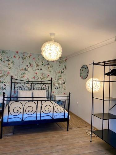 a bedroom with a bed with a floral wall at Apartments Olga in Bled