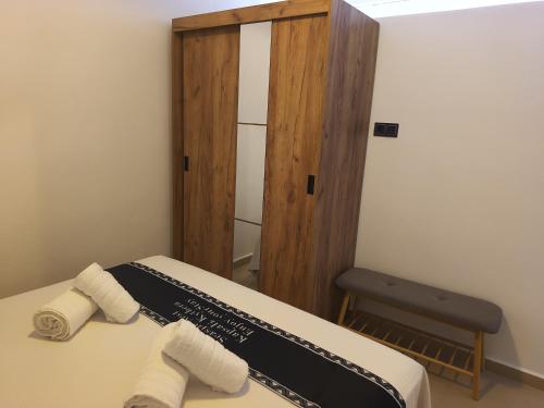 a room with a bed with two towels on it at Seaside Nest in Kythira