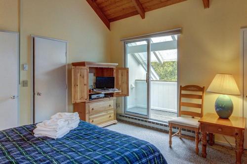 a bedroom with a bed and a desk and a window at Bridges 95 in Warren