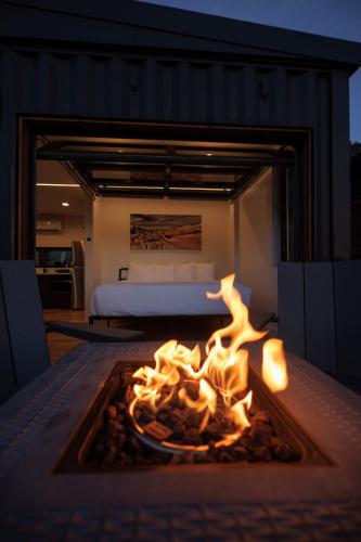 a fireplace in a bedroom with a bed in the background at Iron Cliff in Orderville