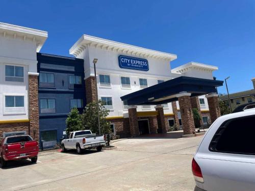 a building with a truck parked in front of it at City Express by Marriott Spring North Houston in Spring