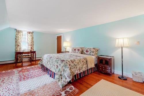 a bedroom with a bed and a table and a lamp at Sweet Berry Farm in Jamaica