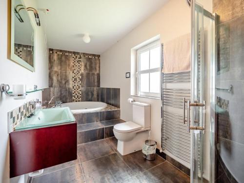 a bathroom with a tub and a toilet and a sink at 4 Bed in Schull oc-ii09887 in Schull