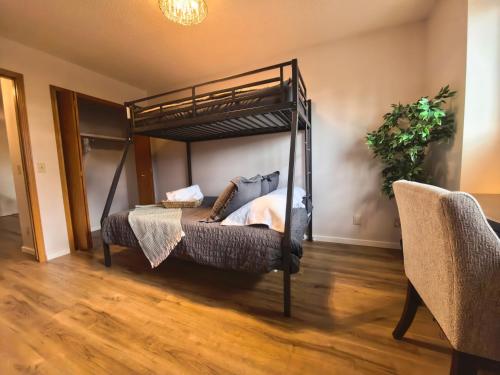 a bedroom with a bunk bed and a couch at Metta Stays Edgemont in Calgary