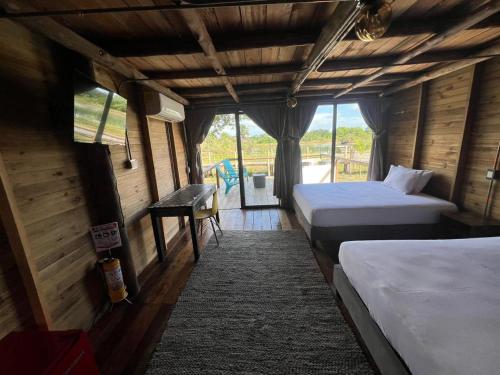 a room with two beds and a view of a playground at Ecopayara Hotel Puerto Gaitán in Puerto Gaitán