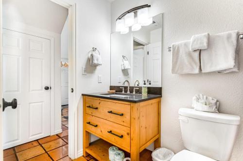 a bathroom with a sink and a toilet and a mirror at Solano Vallejo 3288 in Moab
