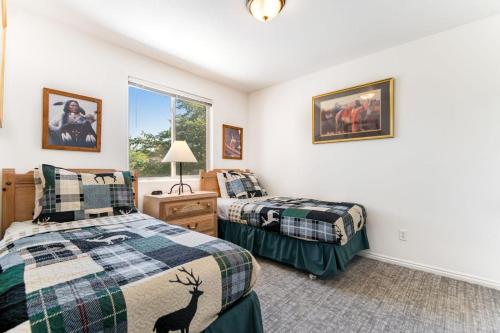 a bedroom with two beds and a window at Solano Vallejo 3288 in Moab