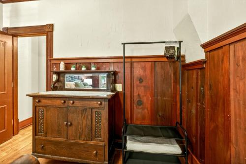 a room with a wooden cabinet and a mirror at Whimsy on B- 2BR & Studio Near OSF in Ashland