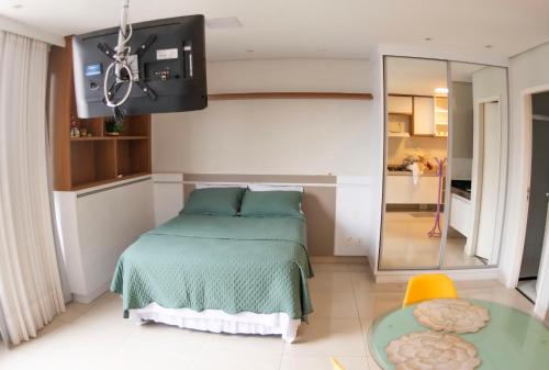a bedroom with a bed and a glass table at Dna Smart Style in Goiânia