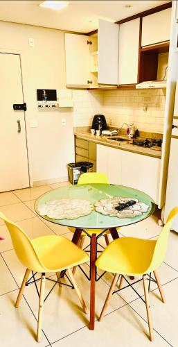 a kitchen with a table and chairs in a room at Dna Smart Style in Goiânia
