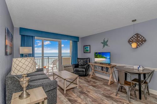 a living room with a couch and a table at Boardwalk 1030 in Myrtle Beach