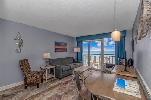 a living room with a couch and a table at Boardwalk 1030 in Myrtle Beach