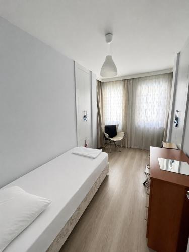 a bedroom with a bed and a desk and a chair at Private Pool Home at Dalyan in Ortaca