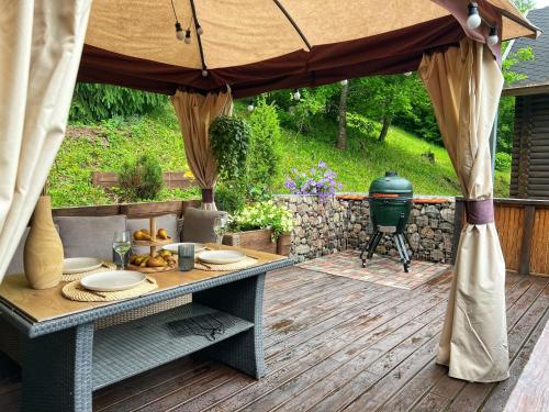 a picnic table under an umbrella on a deck at Kelgumäe in Otepää