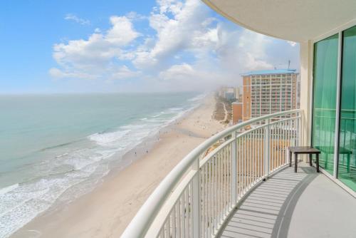 a balcony with a view of the beach and buildings at Sandy Beach 1612 in Myrtle Beach