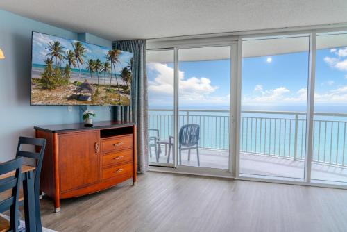 a living room with a view of the ocean at Sandy Beach 1612 in Myrtle Beach
