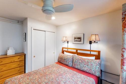a bedroom with a bed and two lamps and a dresser at Mountainside Resort F401 in Stowe