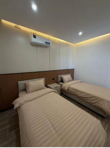 a room with two beds in a room at Royal Pearl Villa 1 in Sowayma