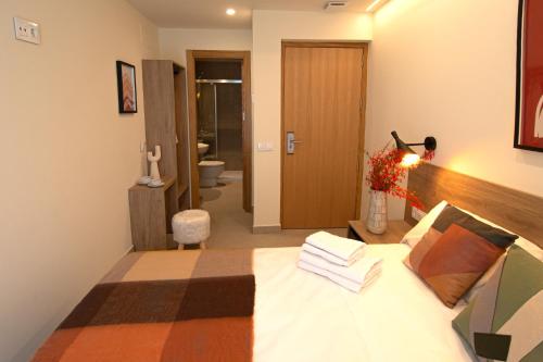 a bedroom with a bed and a person in a room at Luz House Marbella Hostal in Marbella