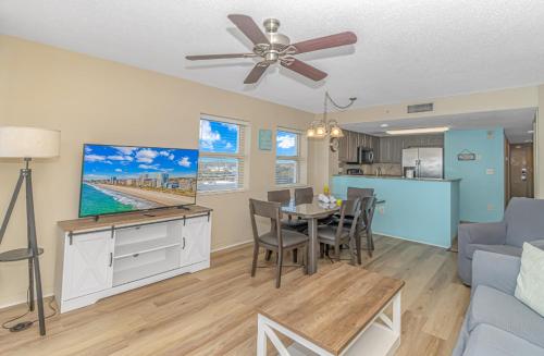 a living room with a ceiling fan and a dining room at Atlantica 757 in Myrtle Beach