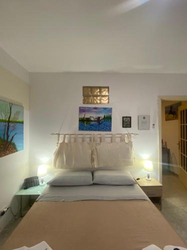 a bedroom with a large bed with two lamps at Casa vacanza La Ninfea intera casa in Caltagirone