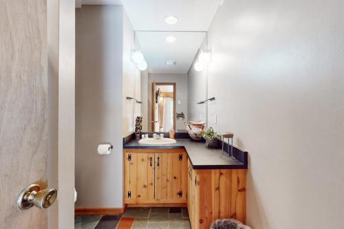 a bathroom with a counter with a sink and a mirror at Suntec Getaway in Dover