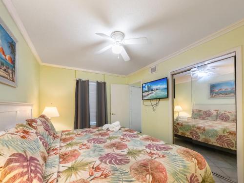 a bedroom with a bed and a ceiling fan at A Place at the Beach 406 in Myrtle Beach