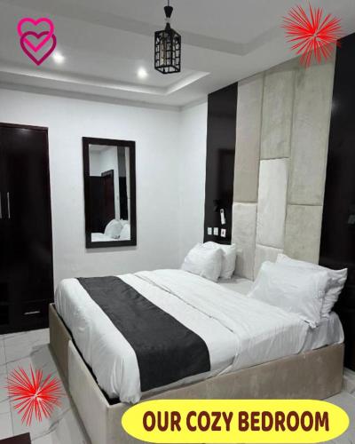 a bedroom with a bed with a black and white comforter at Britney Luxury Apartment in Irete