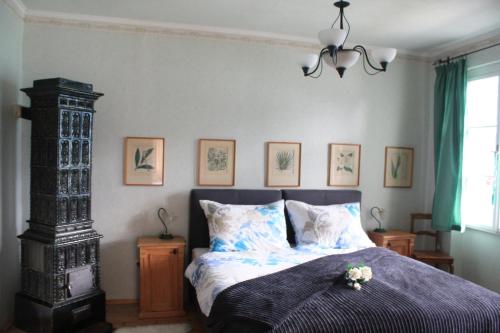 a bedroom with a bed and a chandelier at Villa Helena in Sankt Gilgen