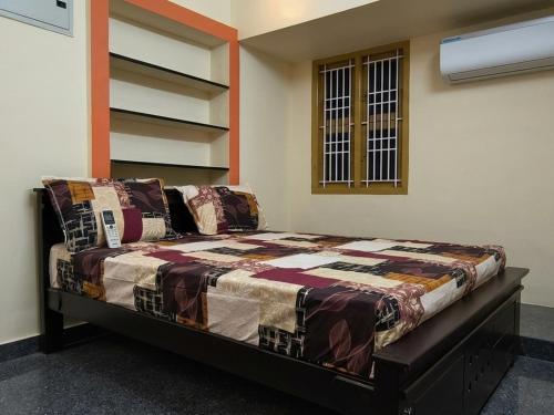 a bedroom with a bed in a room at Fantasy Homestay in Thiruchendur