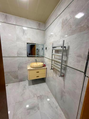 a bathroom with a sink and a mirror at Şuvelan Villa in Baku
