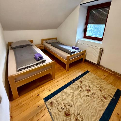 a bedroom with two beds and a window at Apart Jajce in Jajce