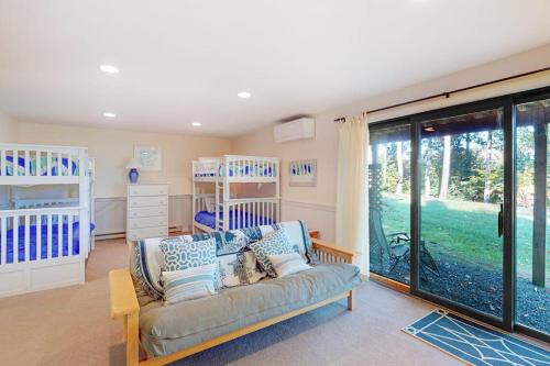 a living room with a couch and two bunk beds at Deere Run 3B in White River Junction
