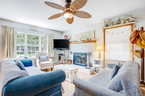 a living room with two blue couches and a fireplace at The Seashell Cottage in Ocean City
